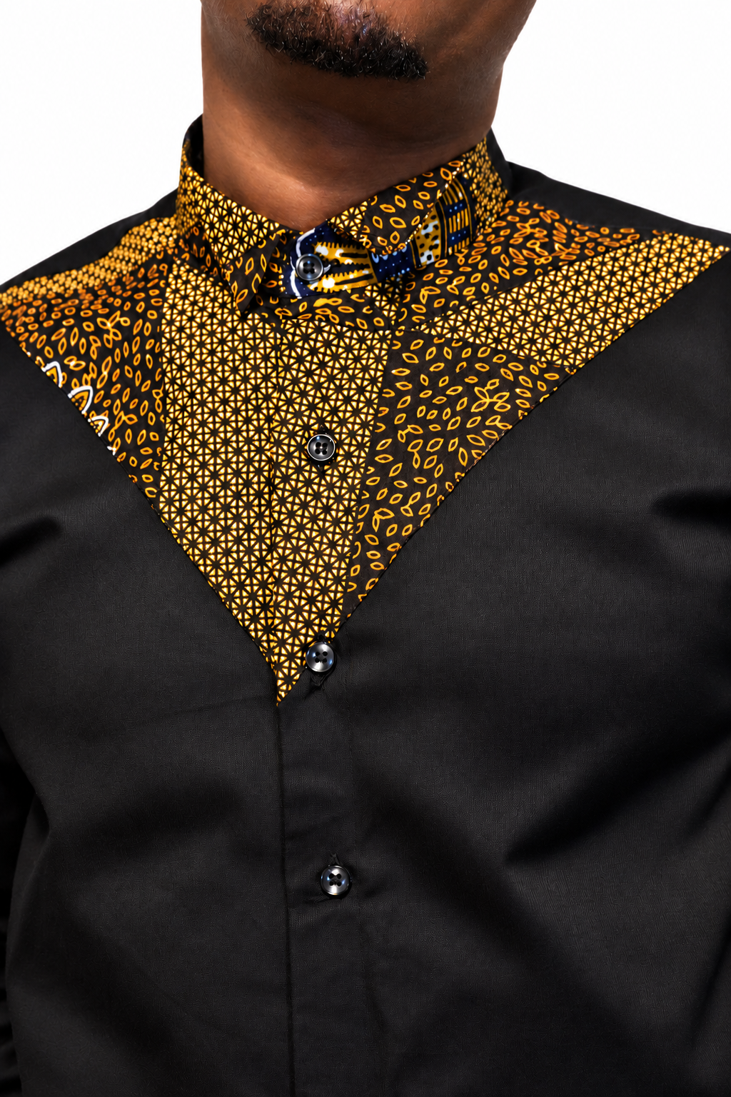 Close-up of Akin shirt collar, gold and navy Ankara panel, stitching and buttons.
