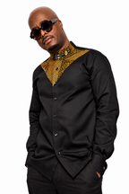 Akin African print shirt styled on model, angled view on white background.