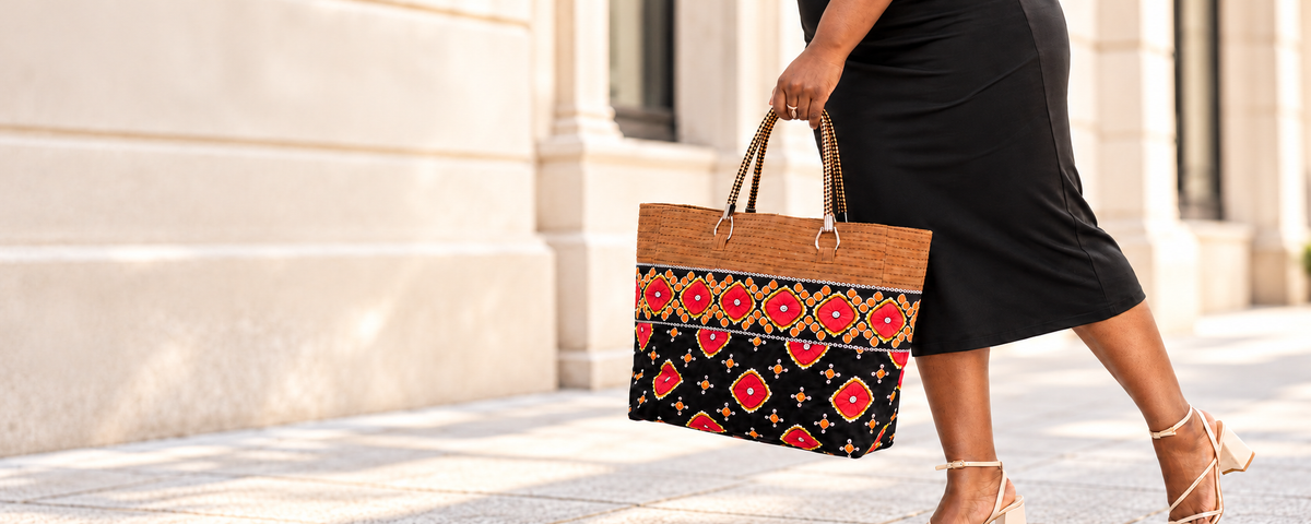 Woman carrying Ewa London’s patterned Adesuwa tote on an elegant London street